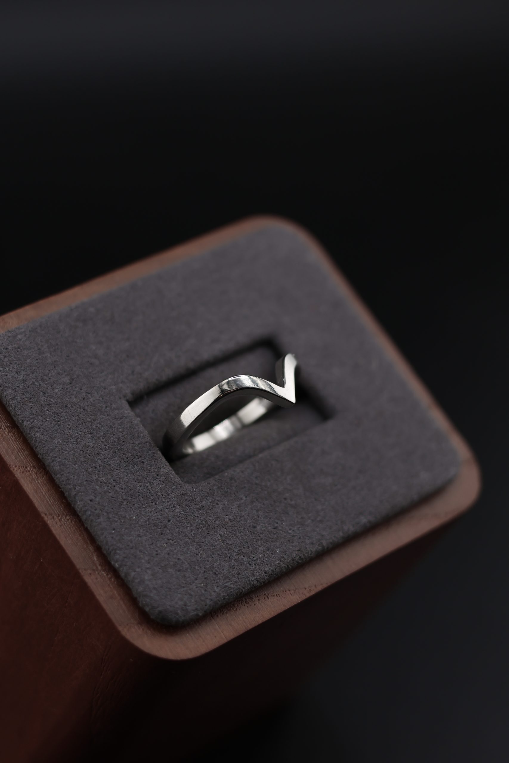 9E2A3610 1.65mm chevron wedding ring with a shaped V profile. Designed to sit neatly against an engagement ring. Slim, precise, and easy to wear. Available in sterling silver, white gold, and platinum. Ideal for women wanting a shaped wedding ring that follows the line of their engagement ring. Handmade in Devon, UK. Crafted by award-winning goldsmith James French at JWF Unique Designs.