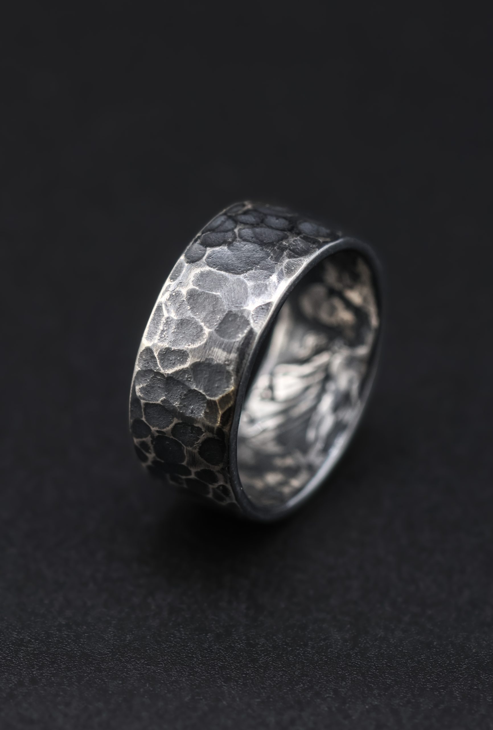 9E2A2166-3 Full crown coin ring in sterling silver with hammered outer texture. Dark patina finish with contrast across the surface. Interior shows St George slaying the dragon from original coin. Slightly rounded profile with a solid, heavy feel. Handmade in Devon, UK.