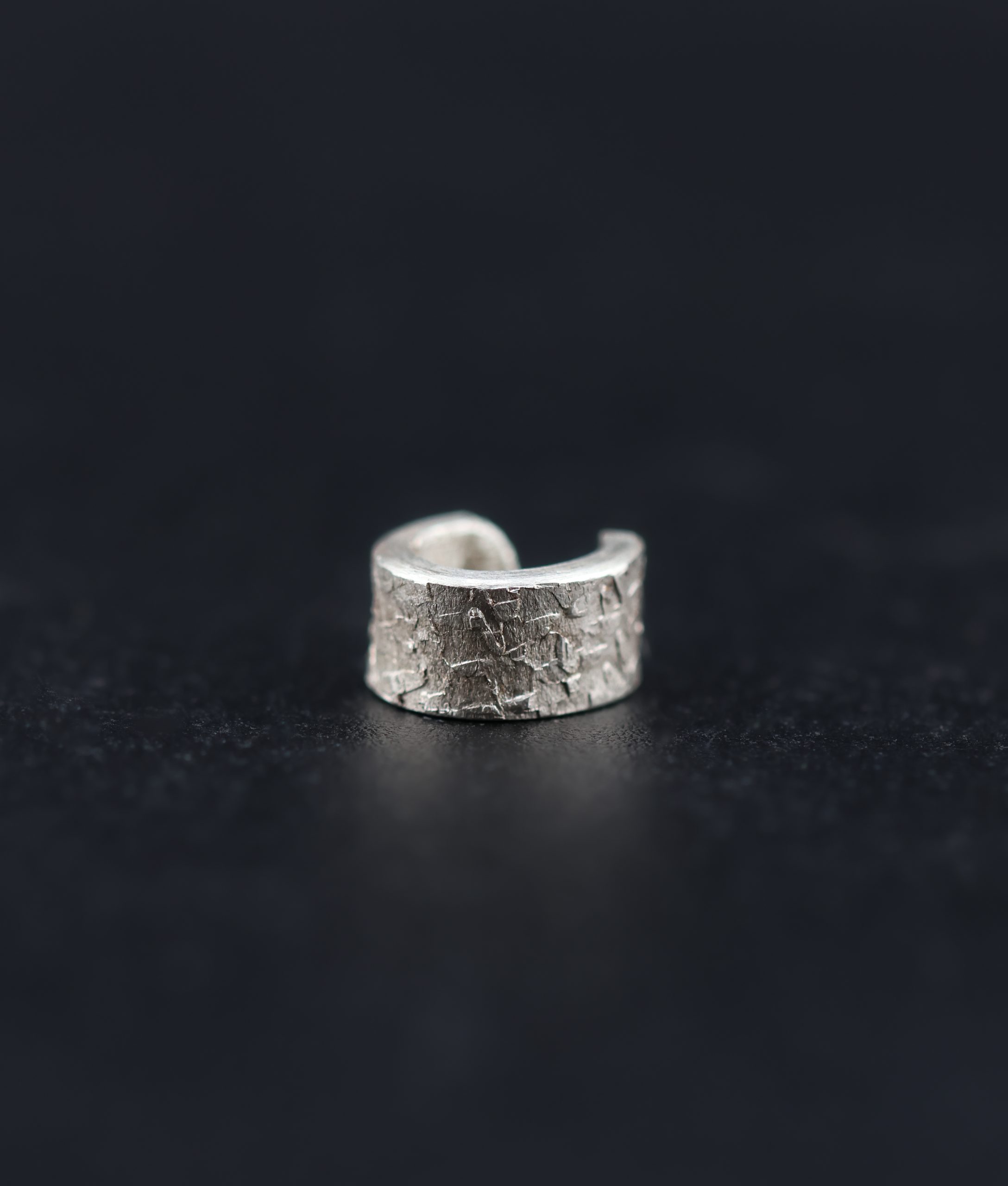 9E2A4163 Handmade sterling silver textured ear cuff inspired by Viking jewellery. Designed for men and women looking for alternative silver jewellery without the need for a piercing. Made in Devon, UK by award-winning goldsmith James French.