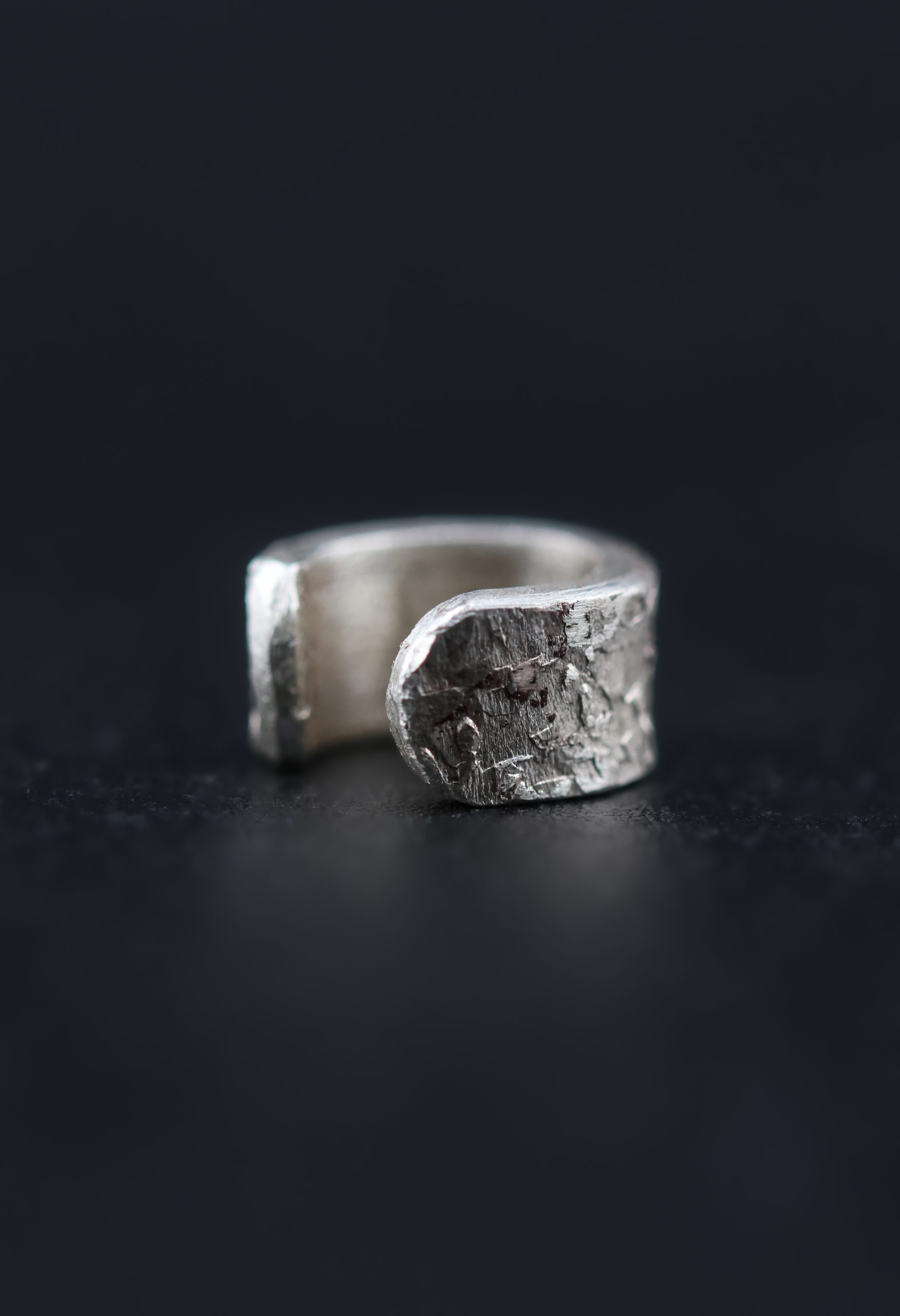 9E2A4164 Handmade sterling silver textured ear cuff inspired by Viking jewellery. Designed for men and women looking for alternative silver jewellery without the need for a piercing. Made in Devon, UK by award-winning goldsmith James French.