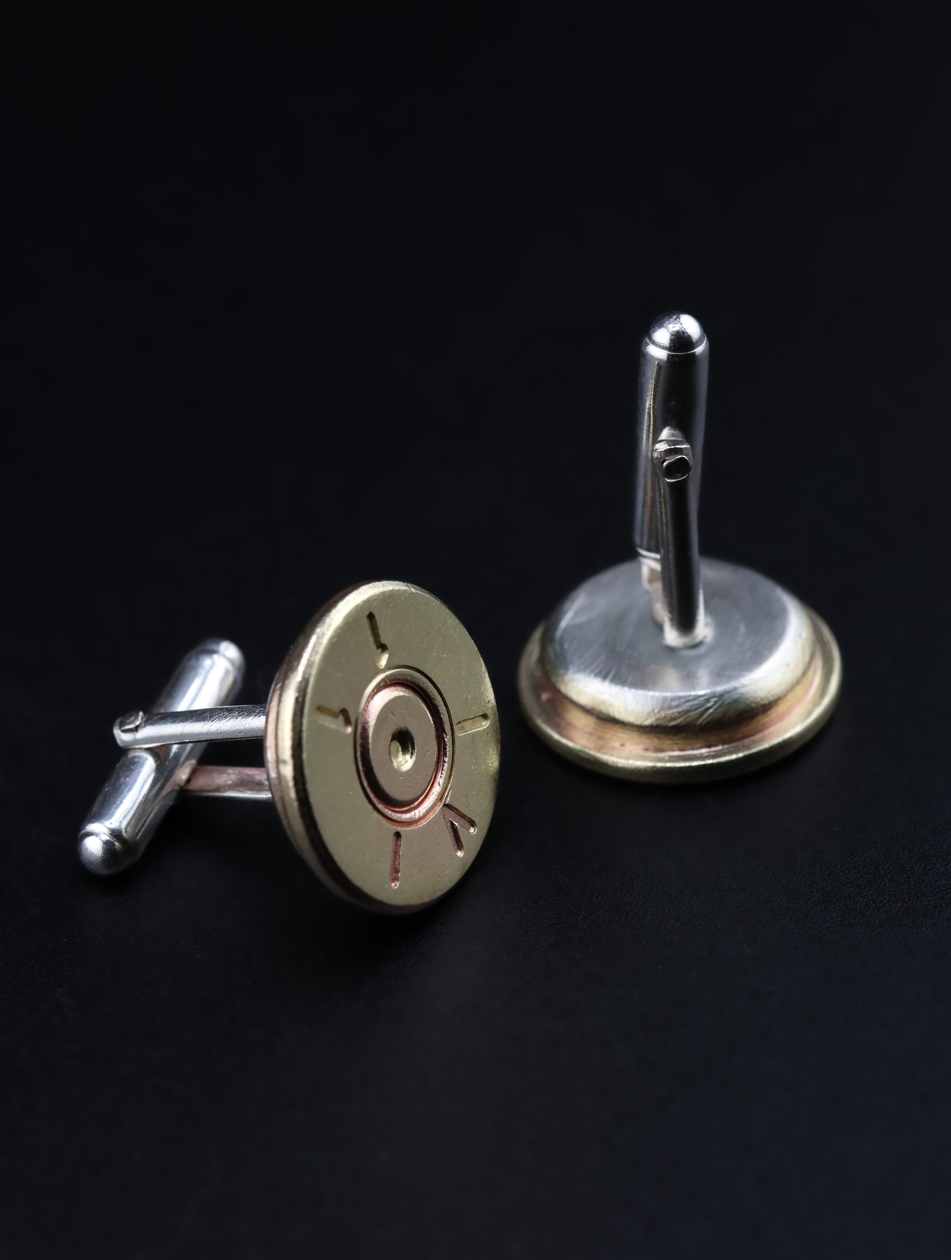 9E2A5785 A pair of genuine brass rifle shell cufflinks with solid sterling silver backs. The original markings remain visible on the front of each shell case. These handmade men’s cufflinks make an unusual gift for a rifle shooter, gamekeeper or country sports enthusiast. Made in Devon by goldsmith James French.